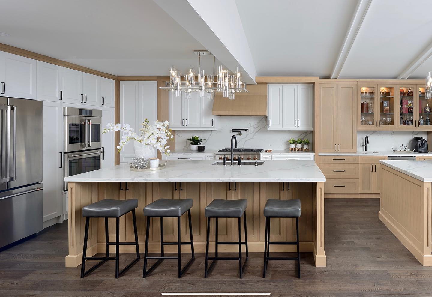 Professionally photographed oak and white kitchen with full-height stone backsplash