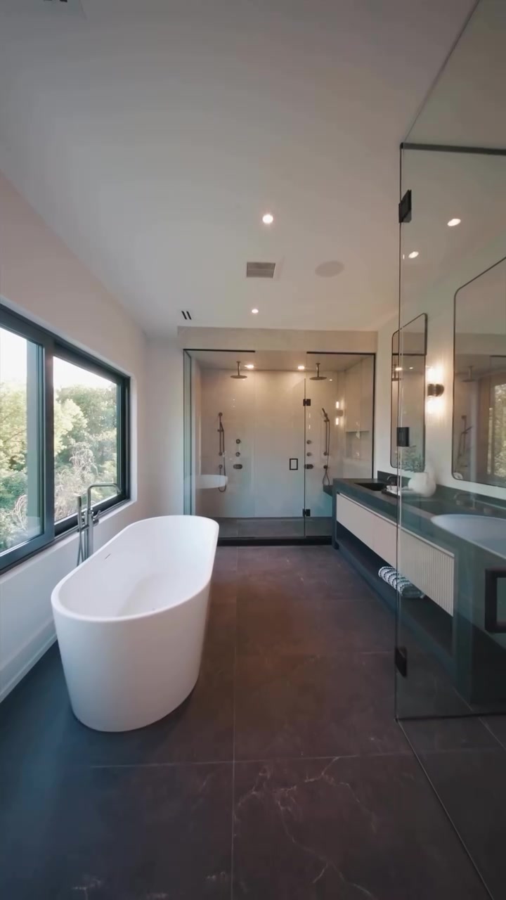 Luxury Lawrence Park Development bathroom with a freestanding tub, walk-in shower, and large-format tiled floor